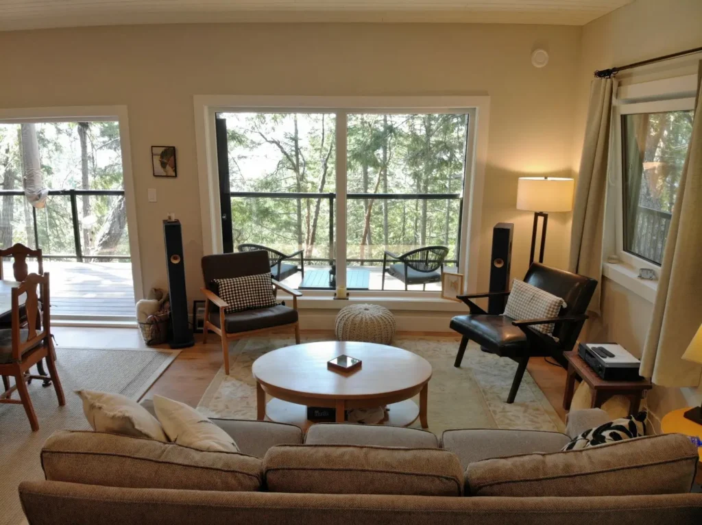 This comfortable living room is the perfect space to look out upon the forest background