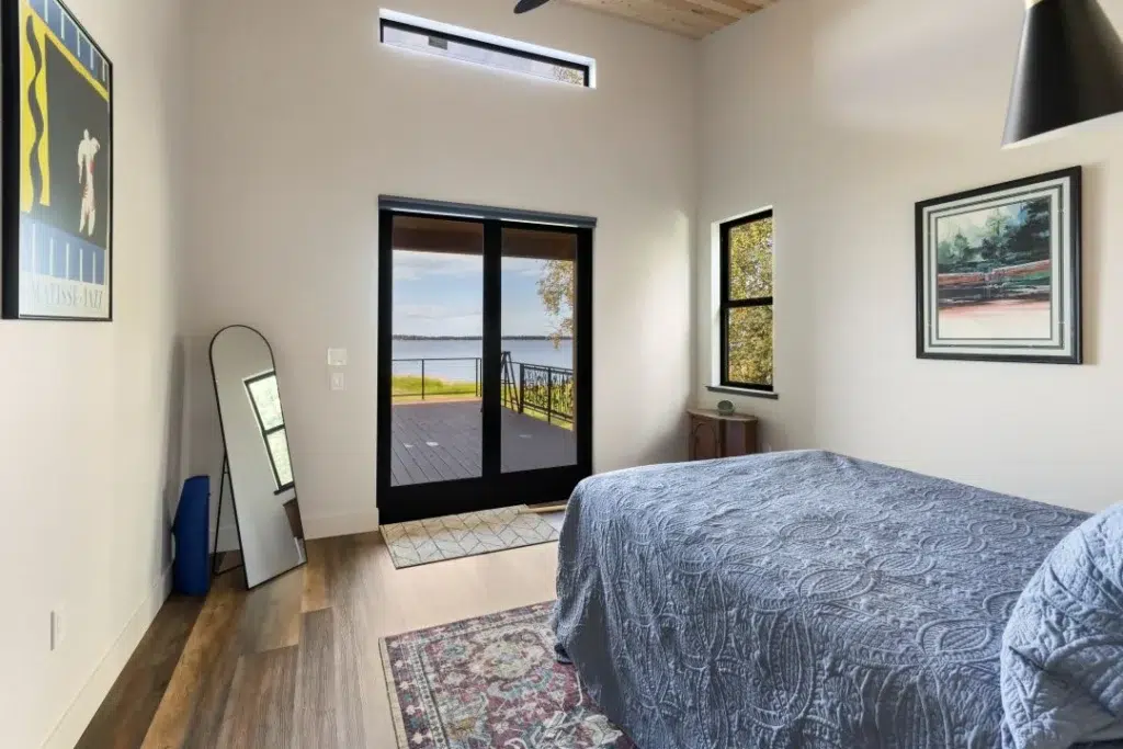 Bedroom that opens up to a lakefront deck
