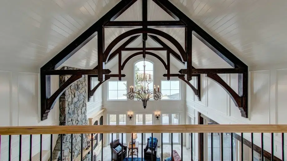 A great room with exposed trusses featured on the vaulted ceilings