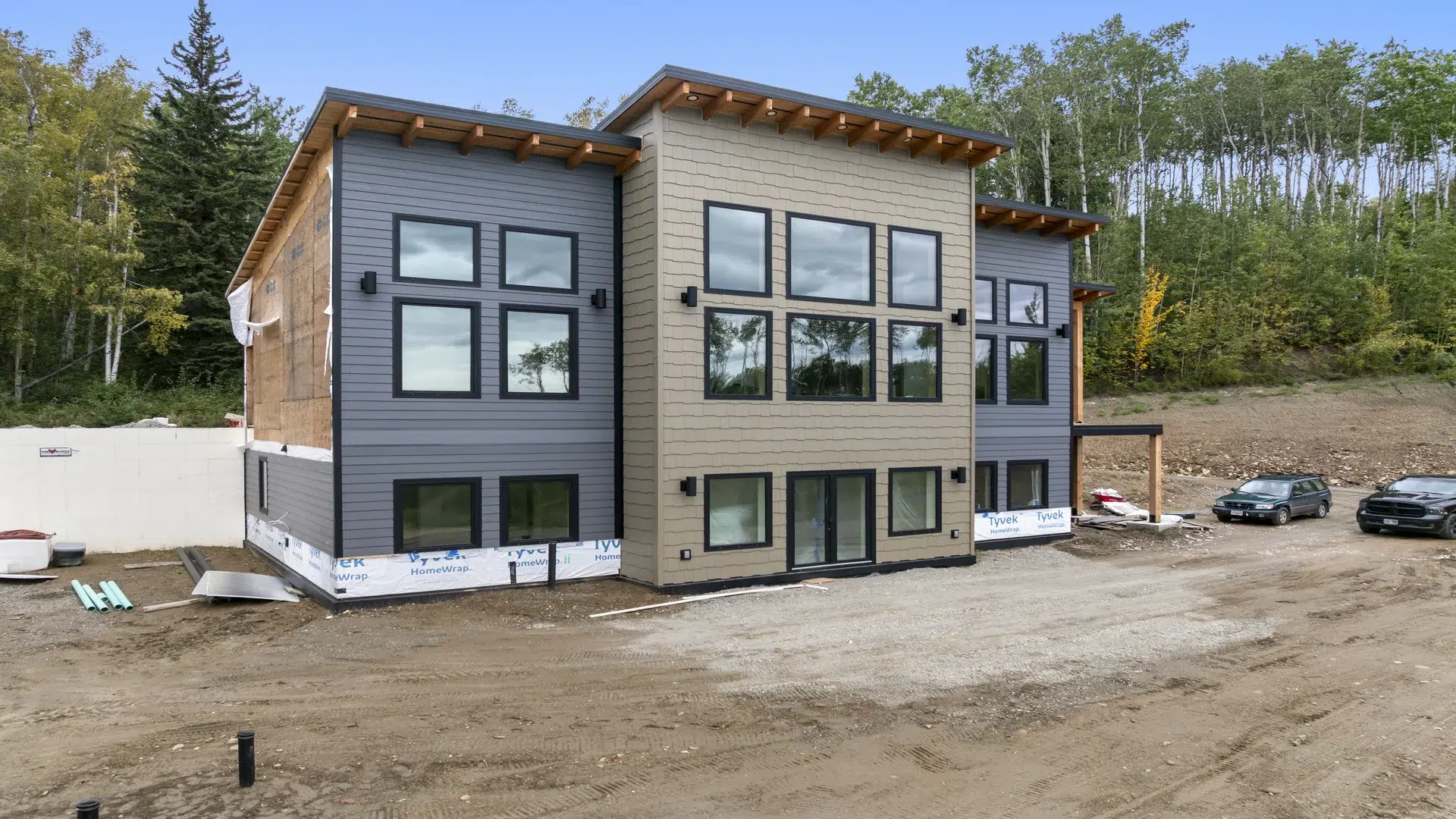 The custom home stands among the forest