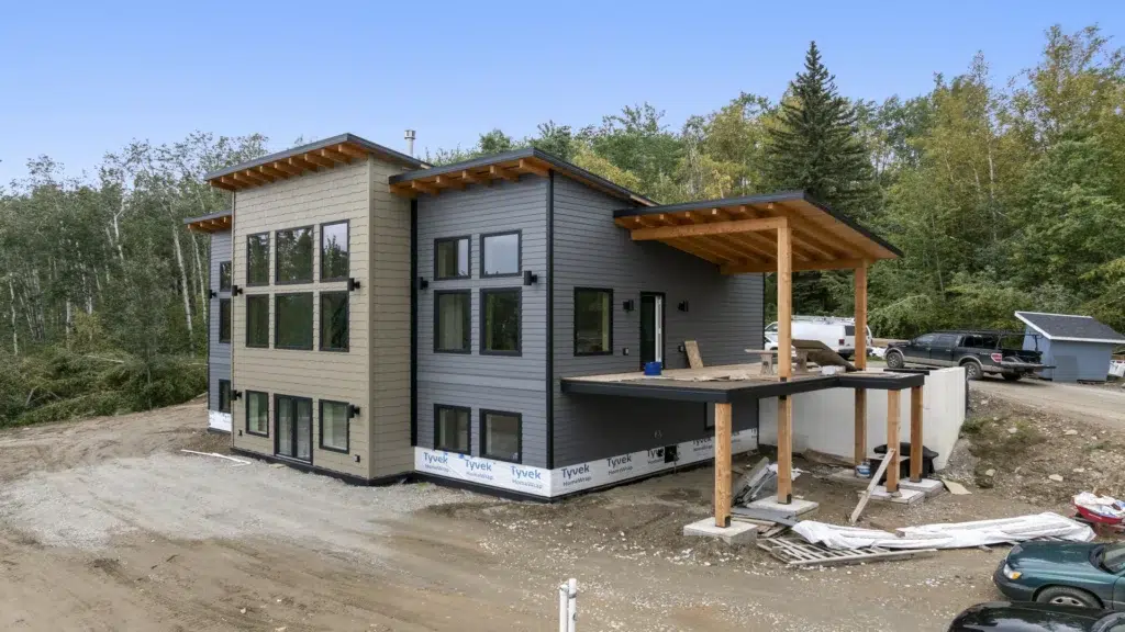 Partially completed house with elevated and covered decking
