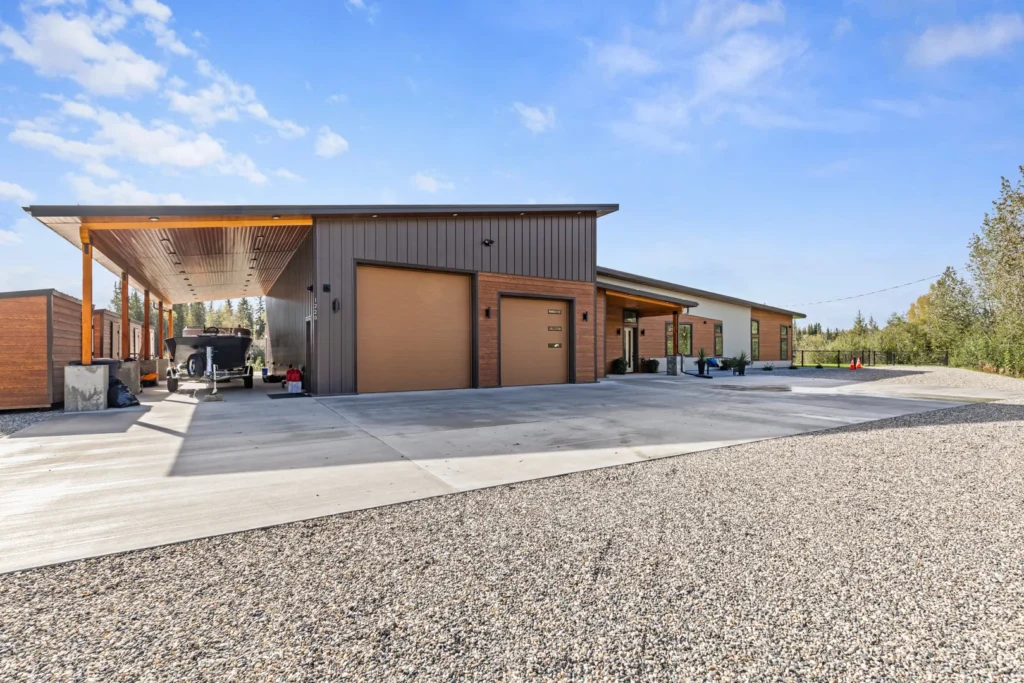 A view from outside the Pacific Home showcases the covered bay that protects a boat from the elements