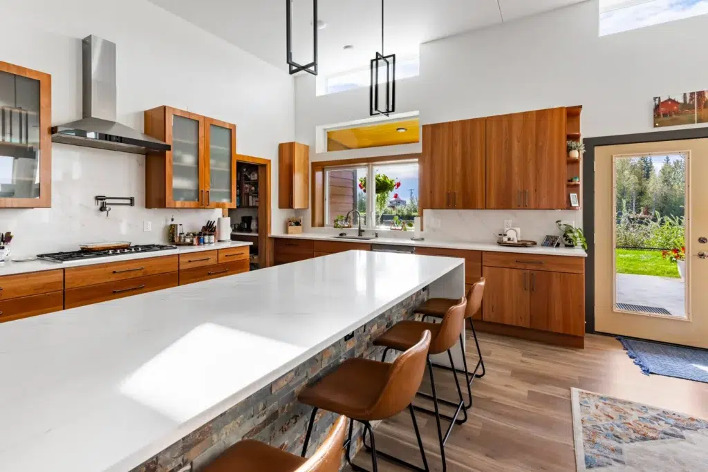 This luxurious kitchen connects to the nearby outdoor living area