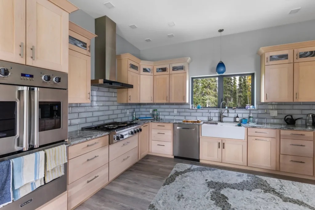 A custom kitchen features maple cabinetry, stainless steel appliances and beautiful granite countertops